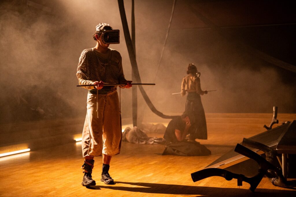 Stage documentation with harp object and performer in smoke