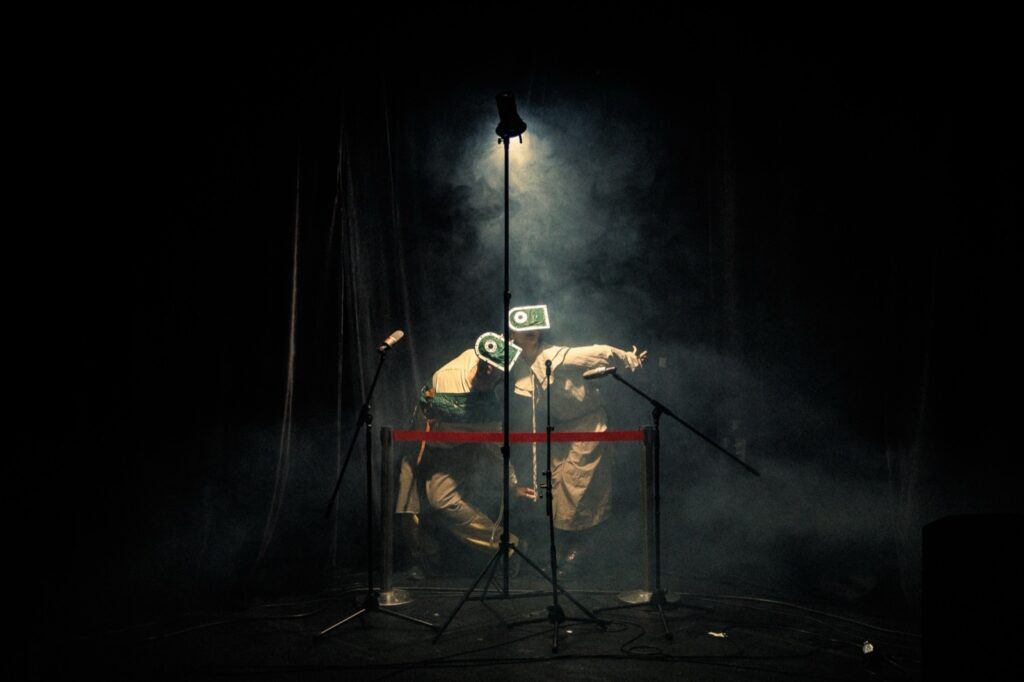 Close image of performer and mask in warm stage light