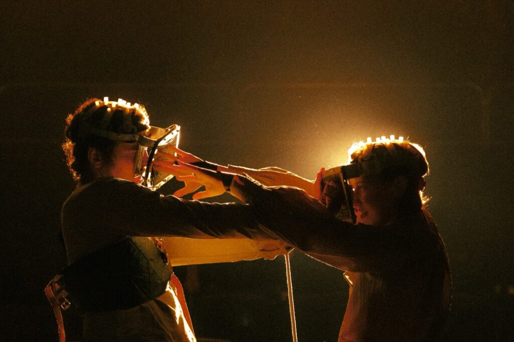 Movement scene with performers in masks